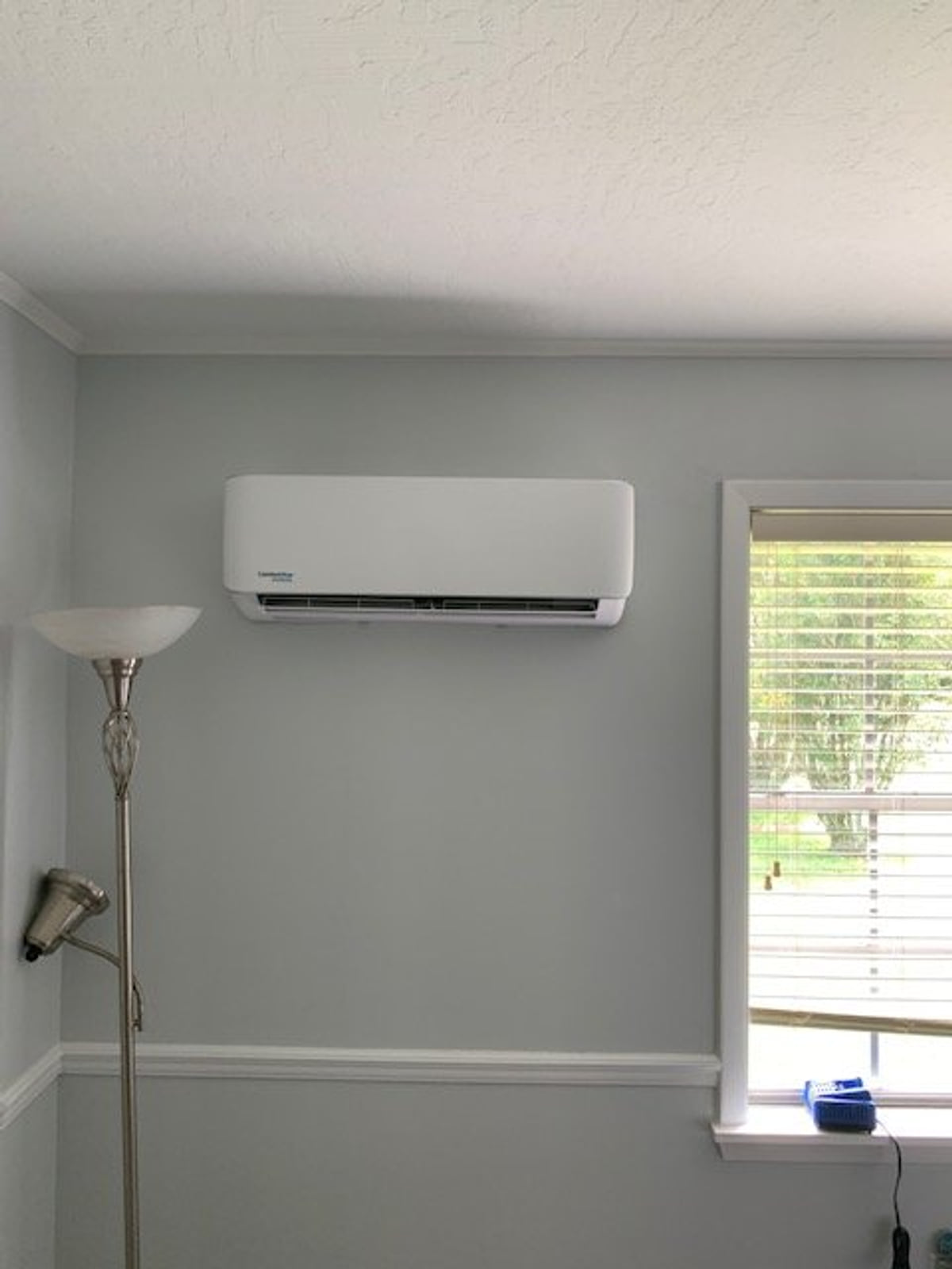 Wall-mounted indoor mini-split unit in a finished living area.